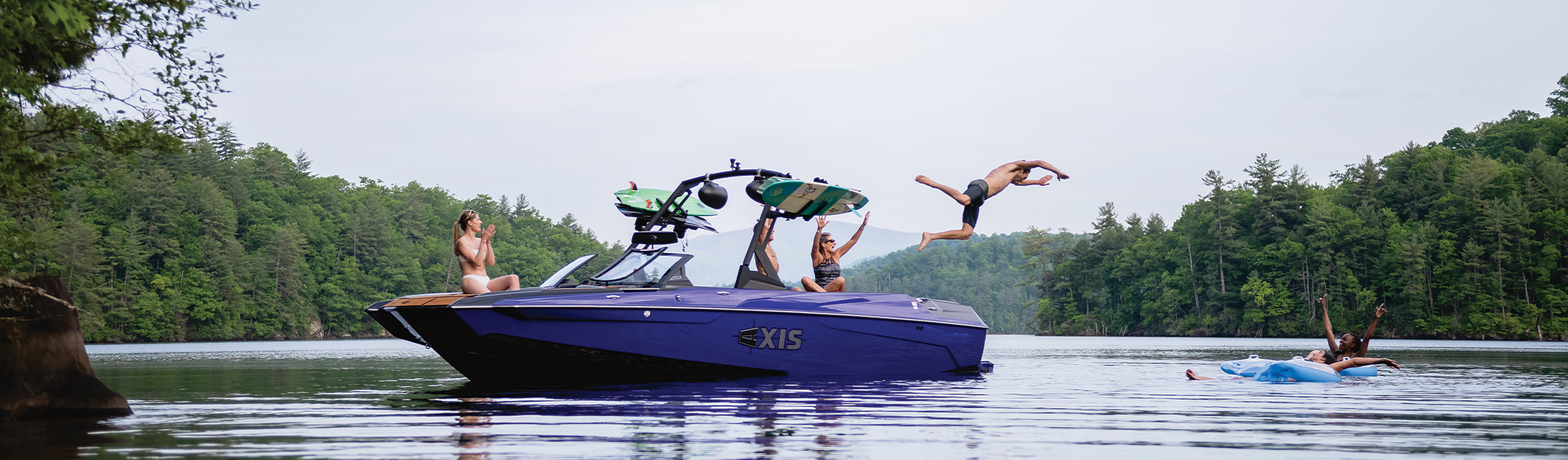 Four people enjoying the lake on an Axis Wake Research® boat